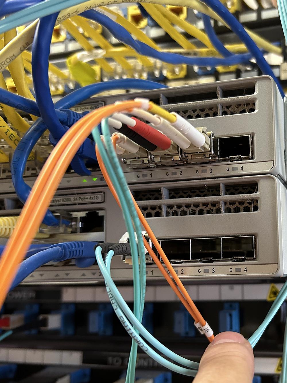 Technician terminating fiber jumpers into industrial switches
