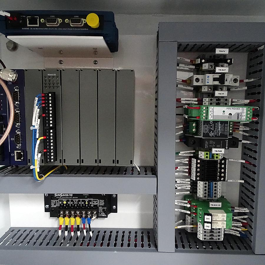 PLC rack panel with I/O modules, breakers and terminal blocks