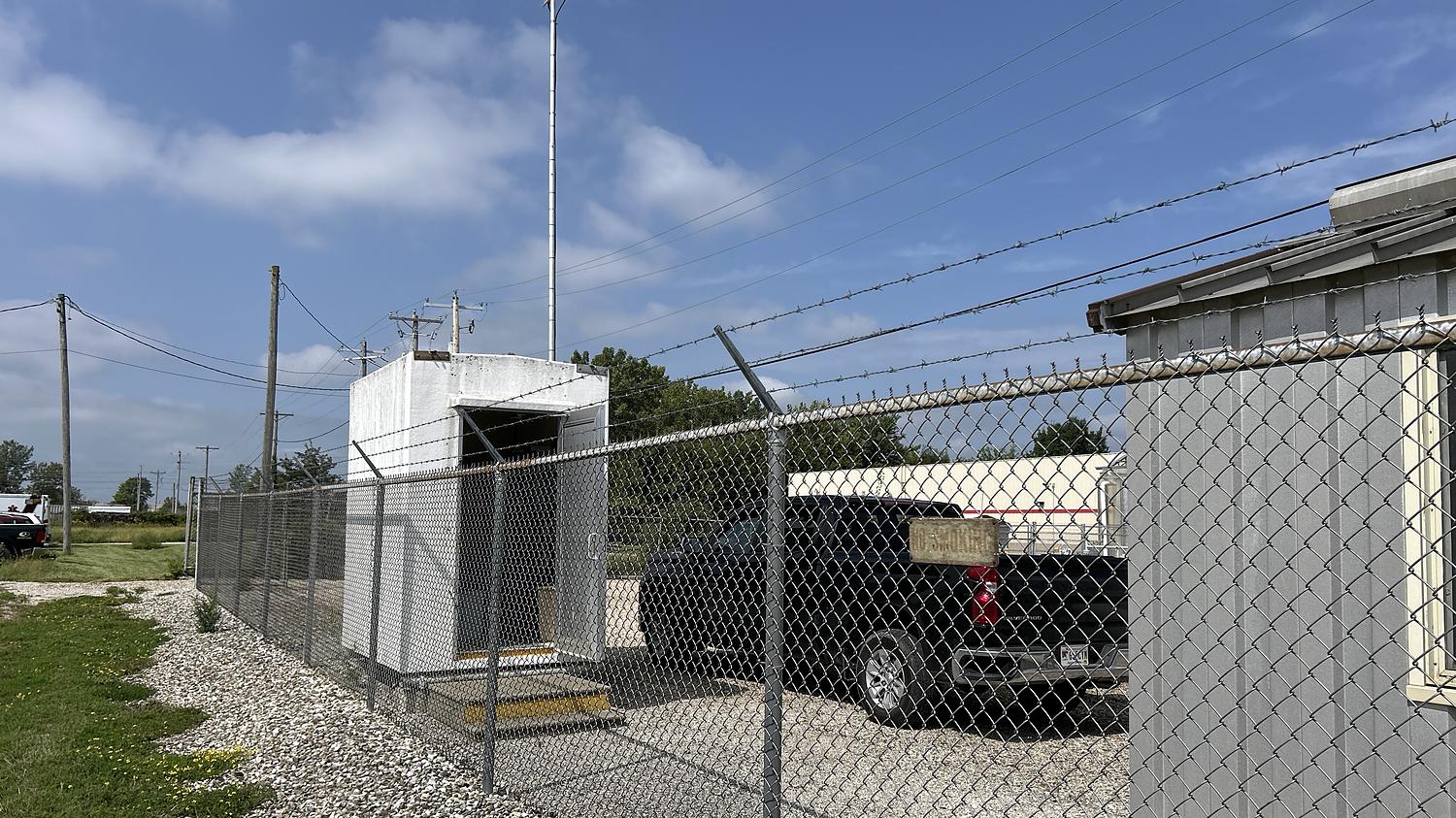 Remote meter station with communications shelter, mast and fenced compound