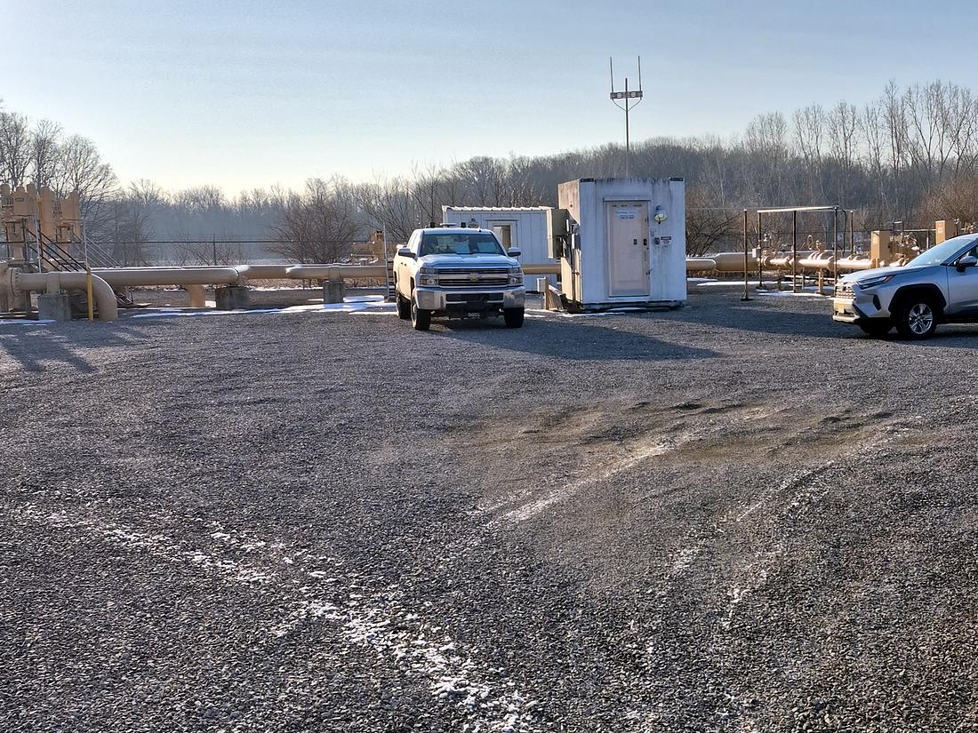 Compressor station compound in winter with crew truck and shelter