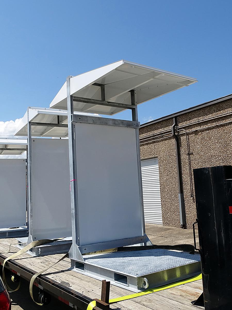 Solar-powered enclosure shelters staged for delivery